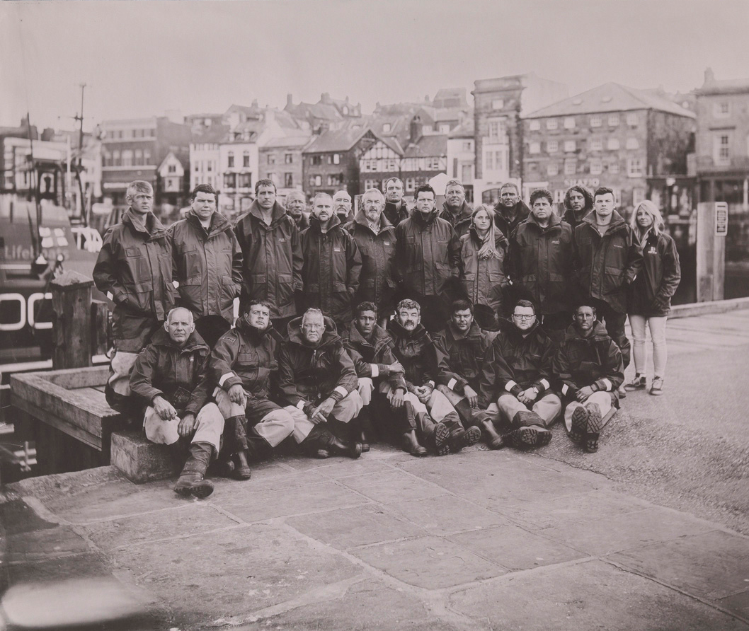 Black and white photograph of a lifeboat crew in Whitby harbour